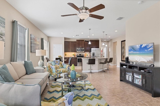 living room featuring light tile patterned flooring and ceiling fan