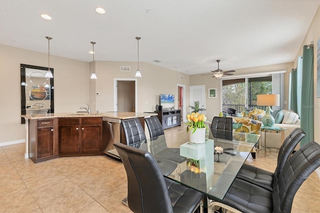 dining area featuring sink, light tile patterned floors, and ceiling fan