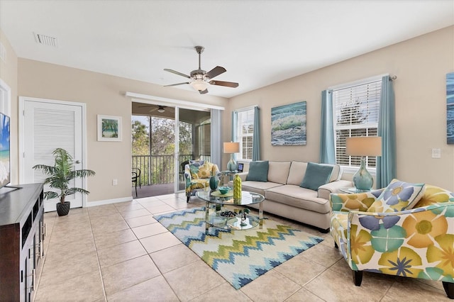 tiled living room with ceiling fan