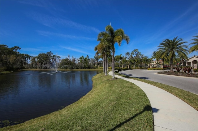 view of community featuring a water view and a lawn