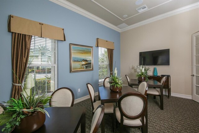 dining area with ornamental molding and carpet flooring