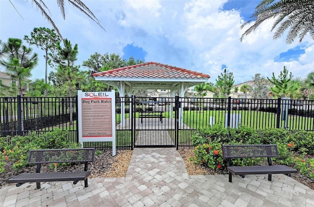 view of gate with a gazebo and a lawn