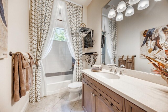 full bathroom with shower / bath combo with shower curtain, toilet, vanity, and tile patterned flooring