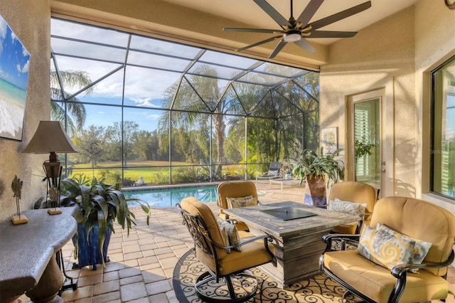 view of patio with ceiling fan and glass enclosure