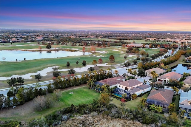 aerial view at dusk with a water view