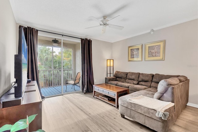 living room with ceiling fan, a textured ceiling, light hardwood / wood-style flooring, and ornamental molding