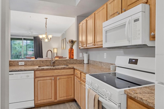 kitchen with sink, white appliances, and light brown cabinets