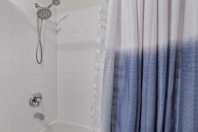 bathroom with shower / bath combination with curtain