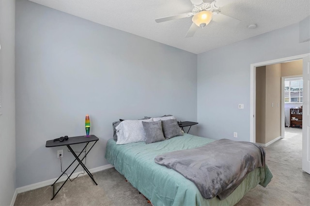 bedroom featuring ceiling fan and light carpet