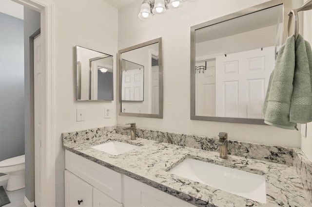 bathroom with toilet and vanity