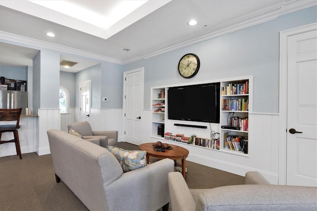 living room with carpet floors, built in shelves, and ornamental molding