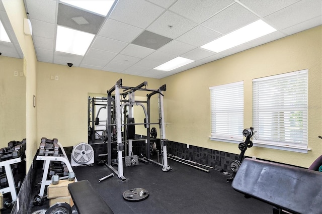 exercise room featuring a paneled ceiling