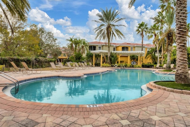 view of swimming pool with a patio and a pergola