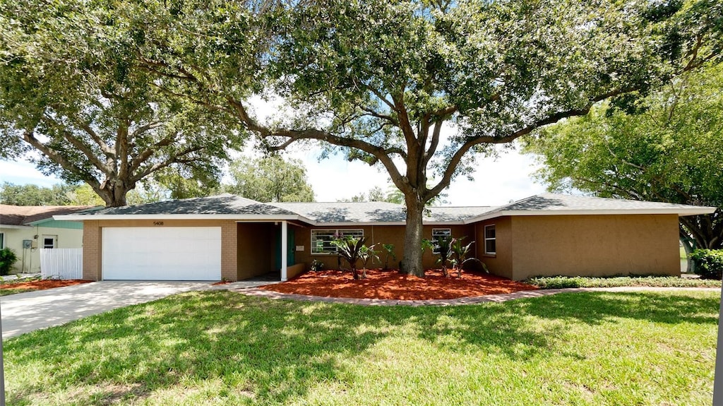 single story home with a front yard and a garage