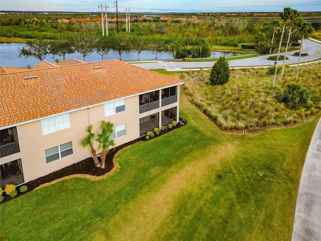 birds eye view of property with a water view