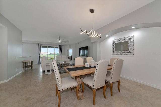 dining space featuring light tile patterned floors and a chandelier