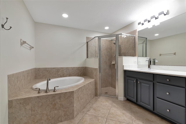 bathroom with tile patterned flooring, shower with separate bathtub, and vanity