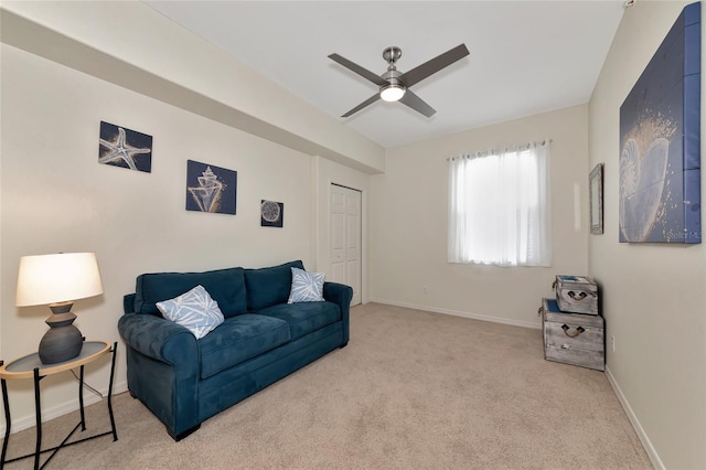 carpeted living room with ceiling fan