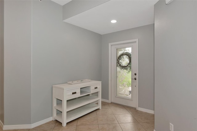 entryway with light tile patterned floors, baseboards, and recessed lighting