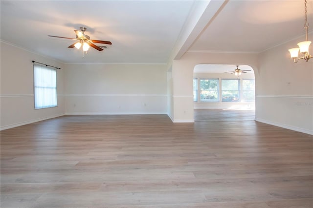 spare room with light hardwood / wood-style floors, a wealth of natural light, and ornamental molding