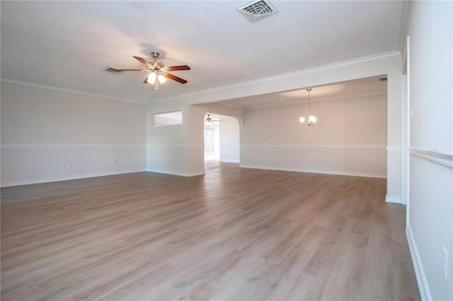 spare room featuring light wood-type flooring, ceiling fan with notable chandelier, and crown molding