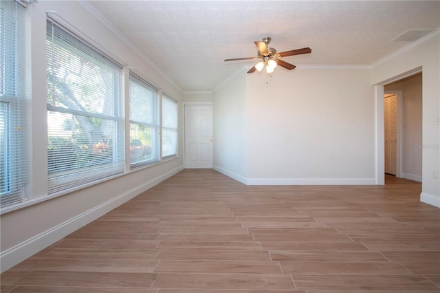 empty room featuring ceiling fan, light hardwood / wood-style floors, and ornamental molding