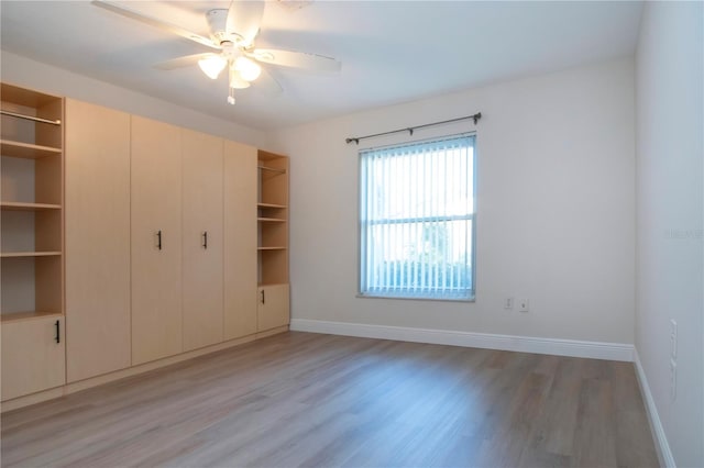 unfurnished bedroom with ceiling fan, light hardwood / wood-style floors, and a closet