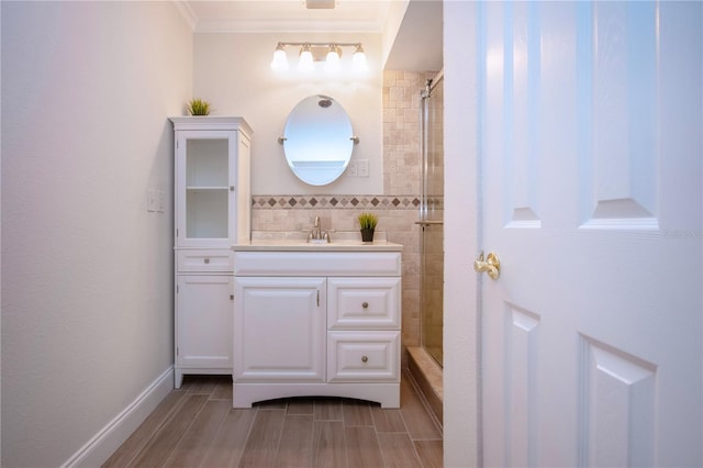 bathroom featuring crown molding, tiled shower, and vanity