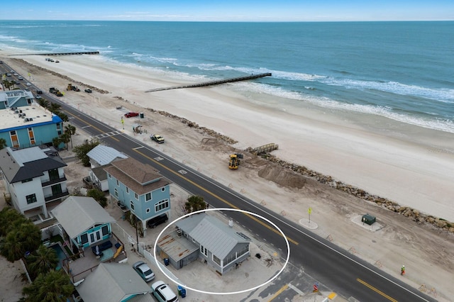 drone / aerial view featuring a view of the beach and a water view