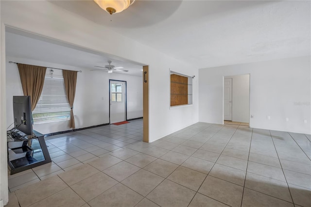 tiled empty room with ceiling fan