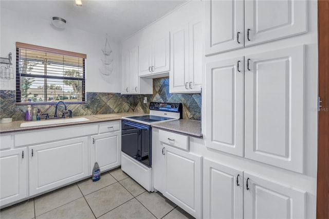 kitchen featuring light tile patterned floors, white cabinetry, decorative backsplash, white electric stove, and sink