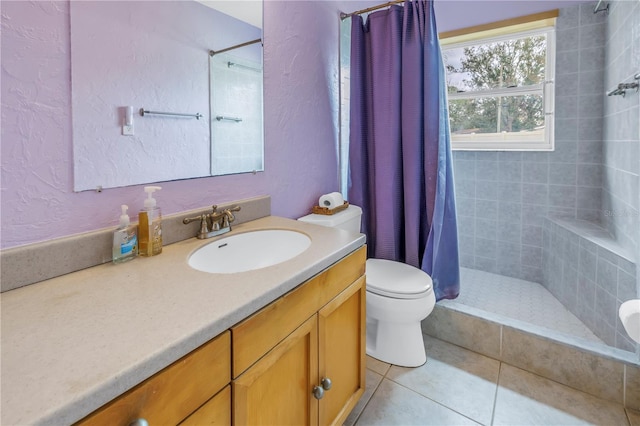 bathroom with toilet, tile patterned flooring, vanity, and curtained shower