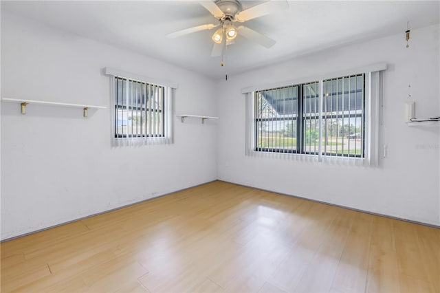 unfurnished room featuring ceiling fan, plenty of natural light, and light hardwood / wood-style floors