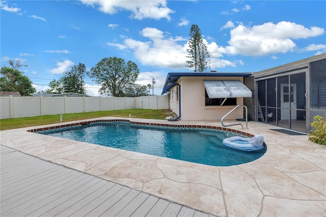 view of pool featuring a sunroom and a patio