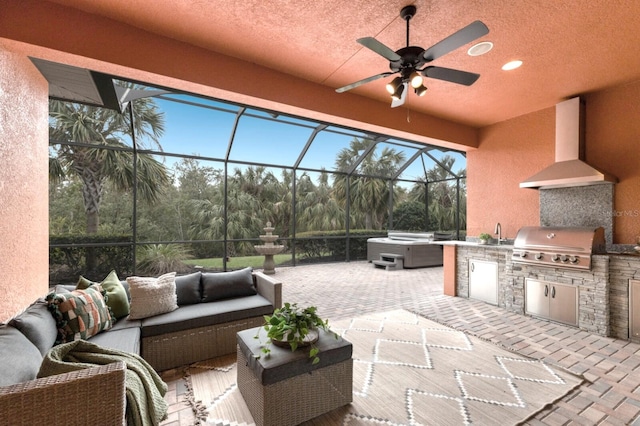 view of patio / terrace with glass enclosure, ceiling fan, an outdoor living space, and area for grilling