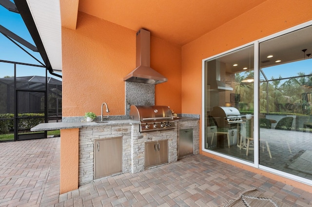 view of patio with grilling area, exterior kitchen, and sink