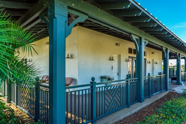 doorway to property featuring stucco siding