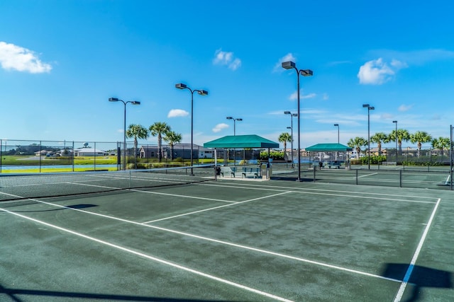 view of tennis court featuring fence