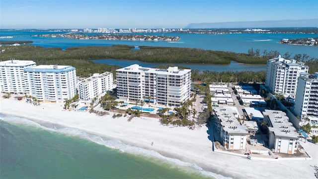 drone / aerial view featuring a view of the beach and a water view