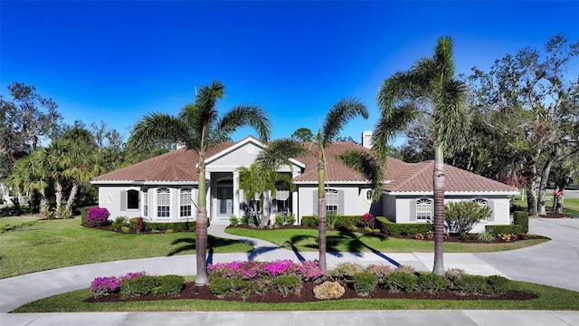 mediterranean / spanish house with a front lawn