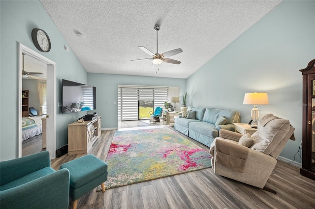living room with hardwood / wood-style flooring, vaulted ceiling, a textured ceiling, and ceiling fan