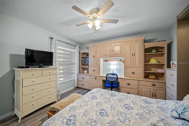 bedroom featuring ceiling fan, dark hardwood / wood-style floors, and a textured ceiling