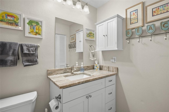bathroom featuring vanity and toilet