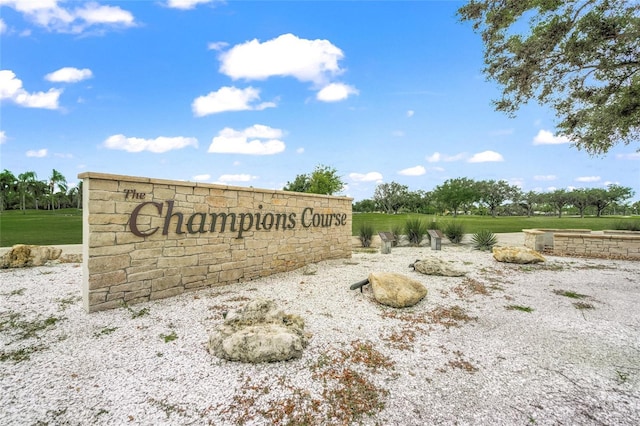 community sign featuring a lawn