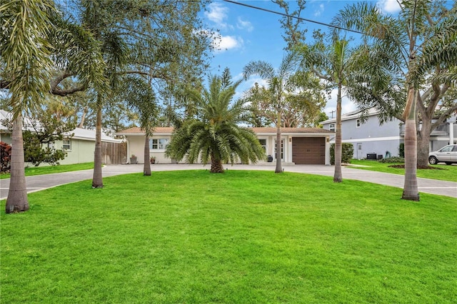 ranch-style home featuring a front yard and a garage