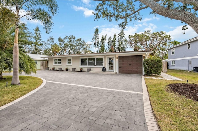 ranch-style home featuring a garage and a front yard