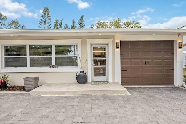 doorway to property with a garage