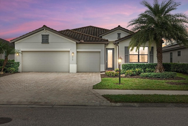 mediterranean / spanish-style home with a garage