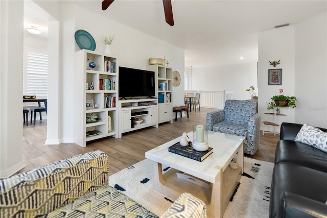 living room featuring ceiling fan and light hardwood / wood-style flooring