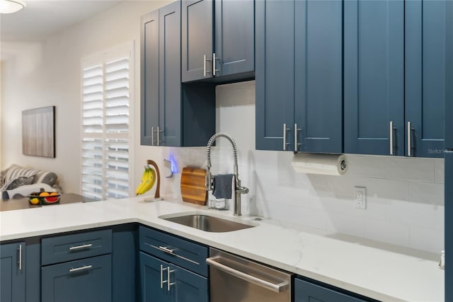 kitchen featuring sink, dishwasher, and blue cabinetry